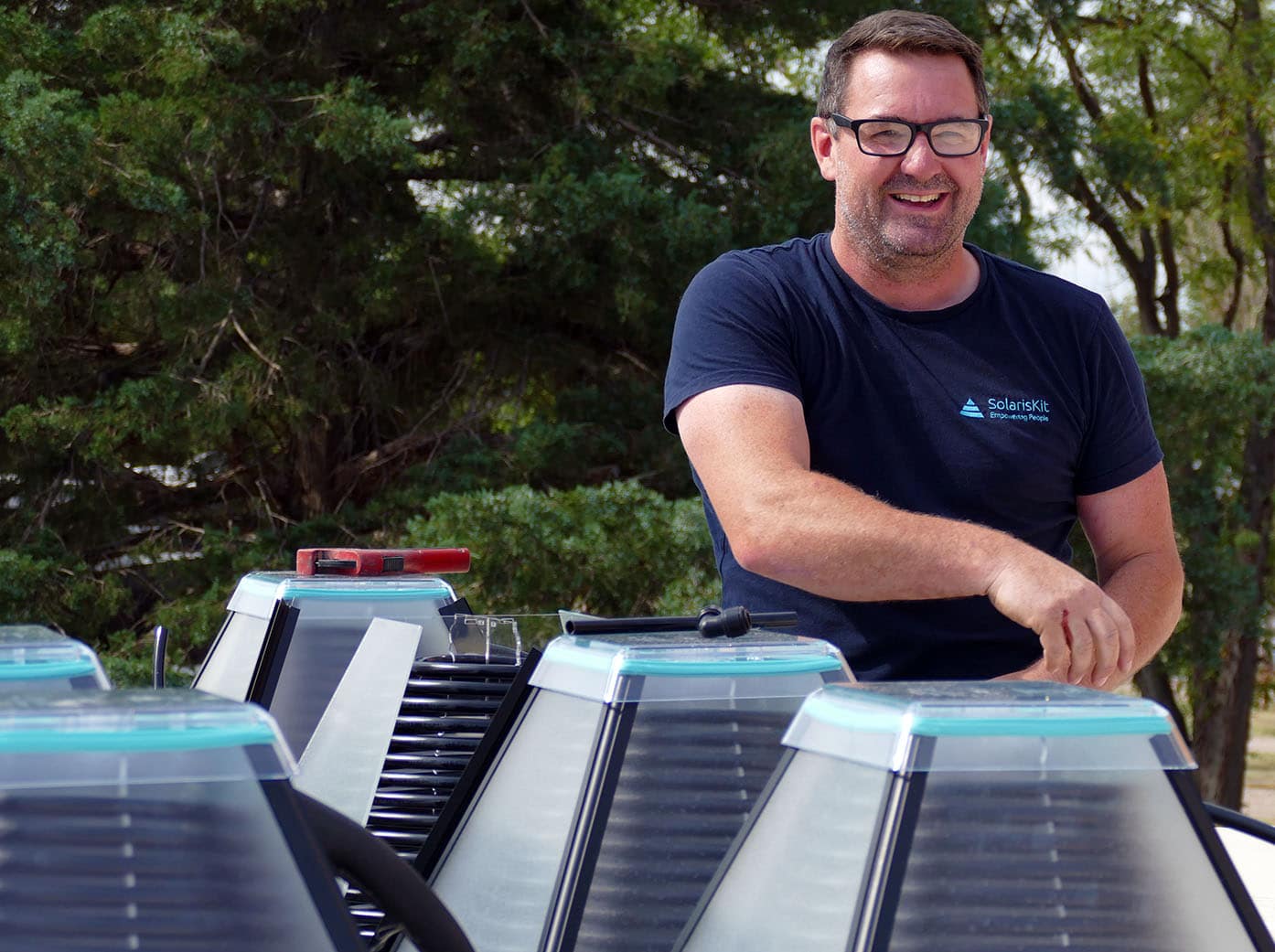 Kris installing SolarisKit solar collectors (cropped)